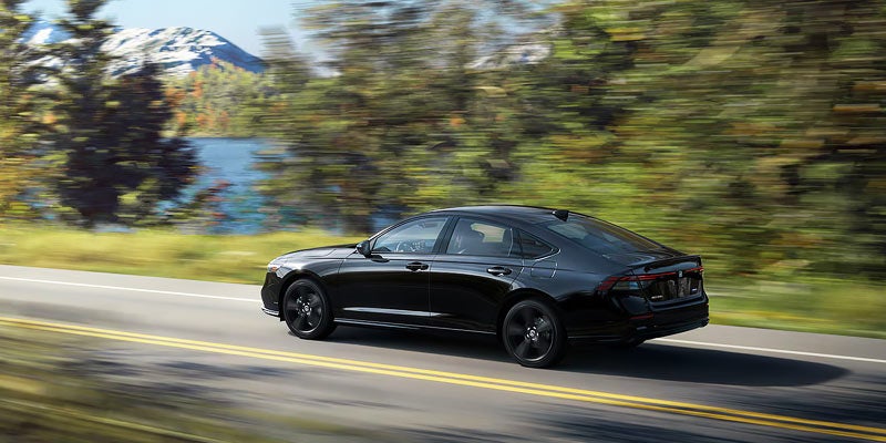 A black car driving on the road.