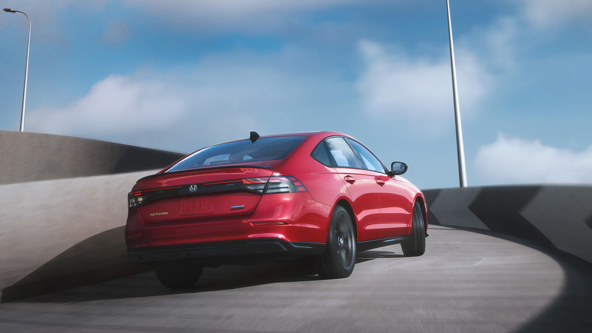 A red car driving up a ramp.