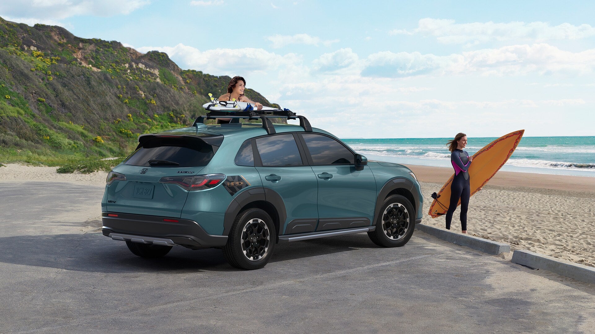 a red honda hr-v turning right in the city with crosswalks