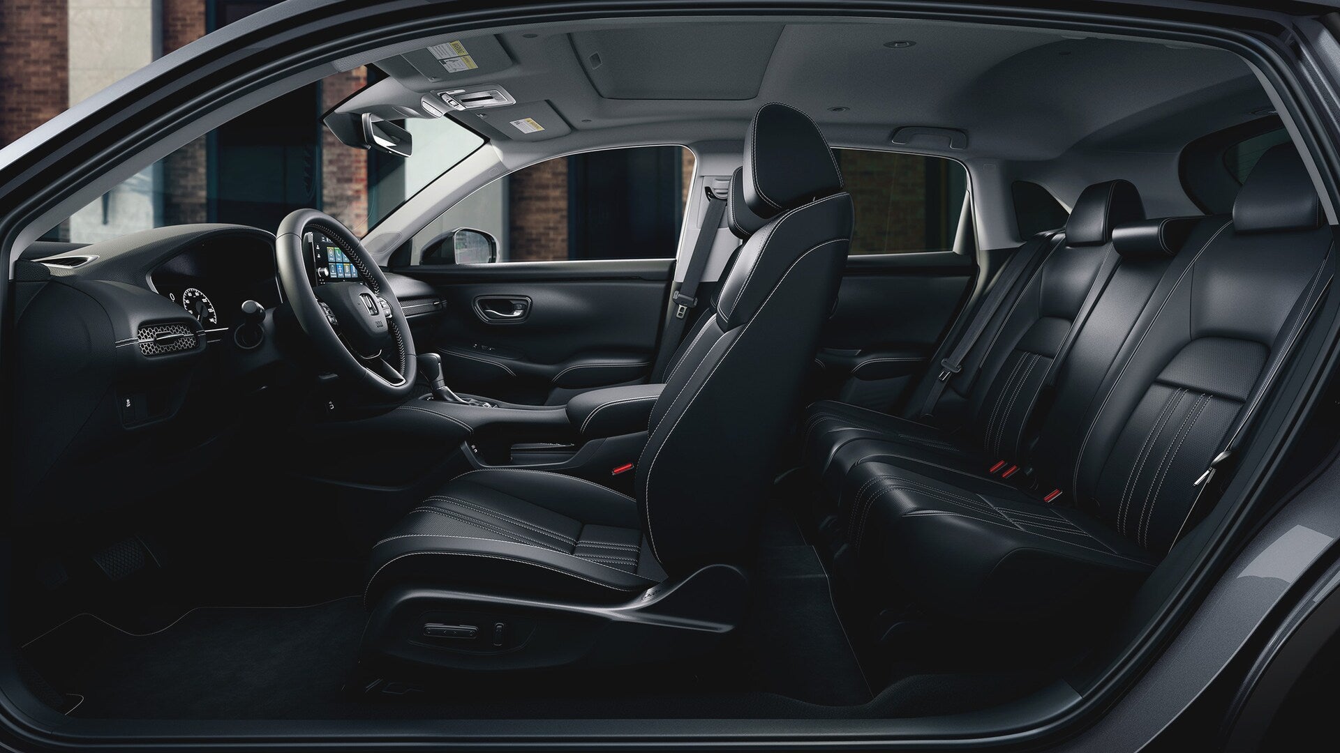 the complete side view interior of a 2025 honda hr-v showcasing seating for 5 and technology