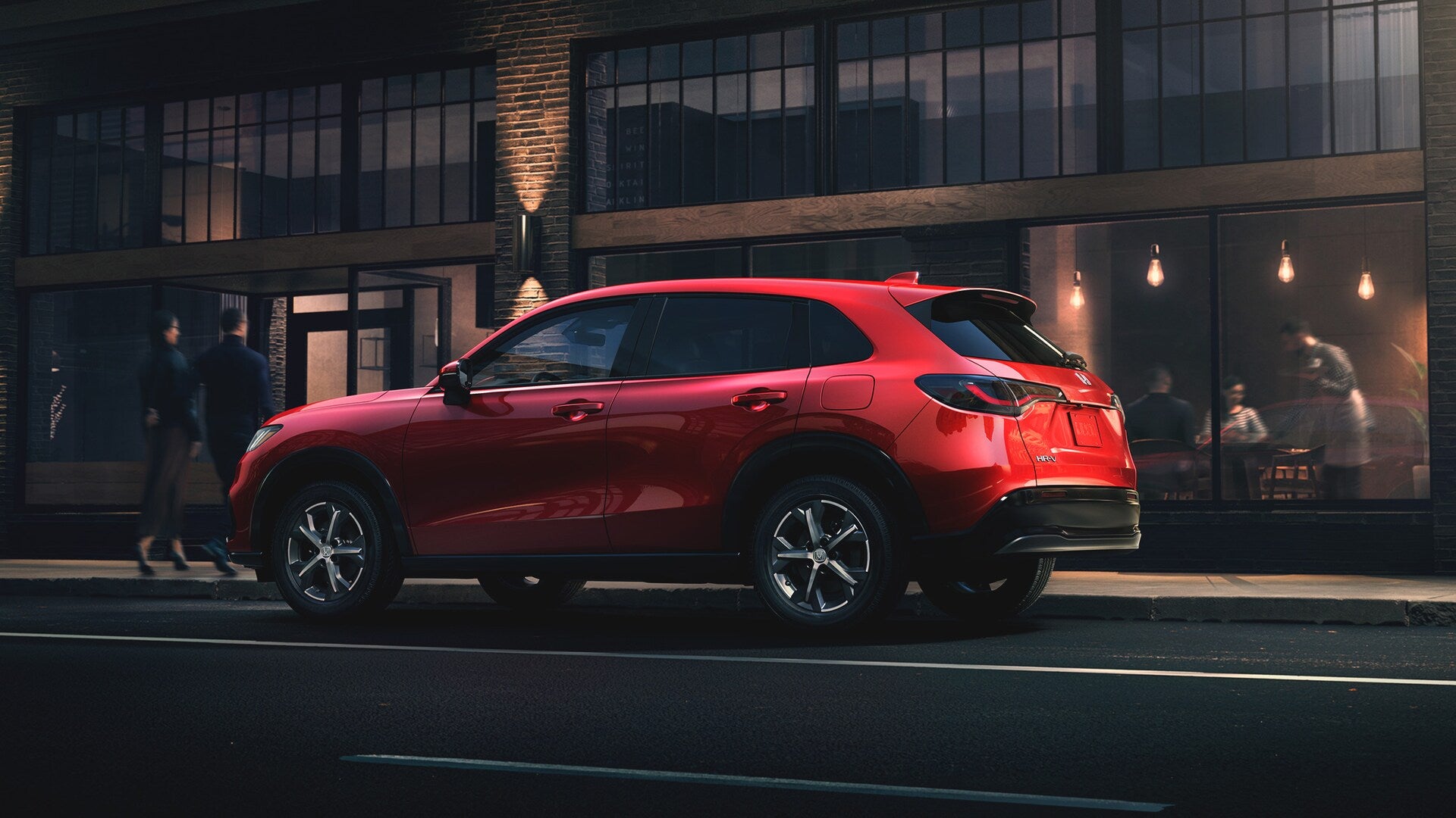 a red honda hr-v suv driving in the city