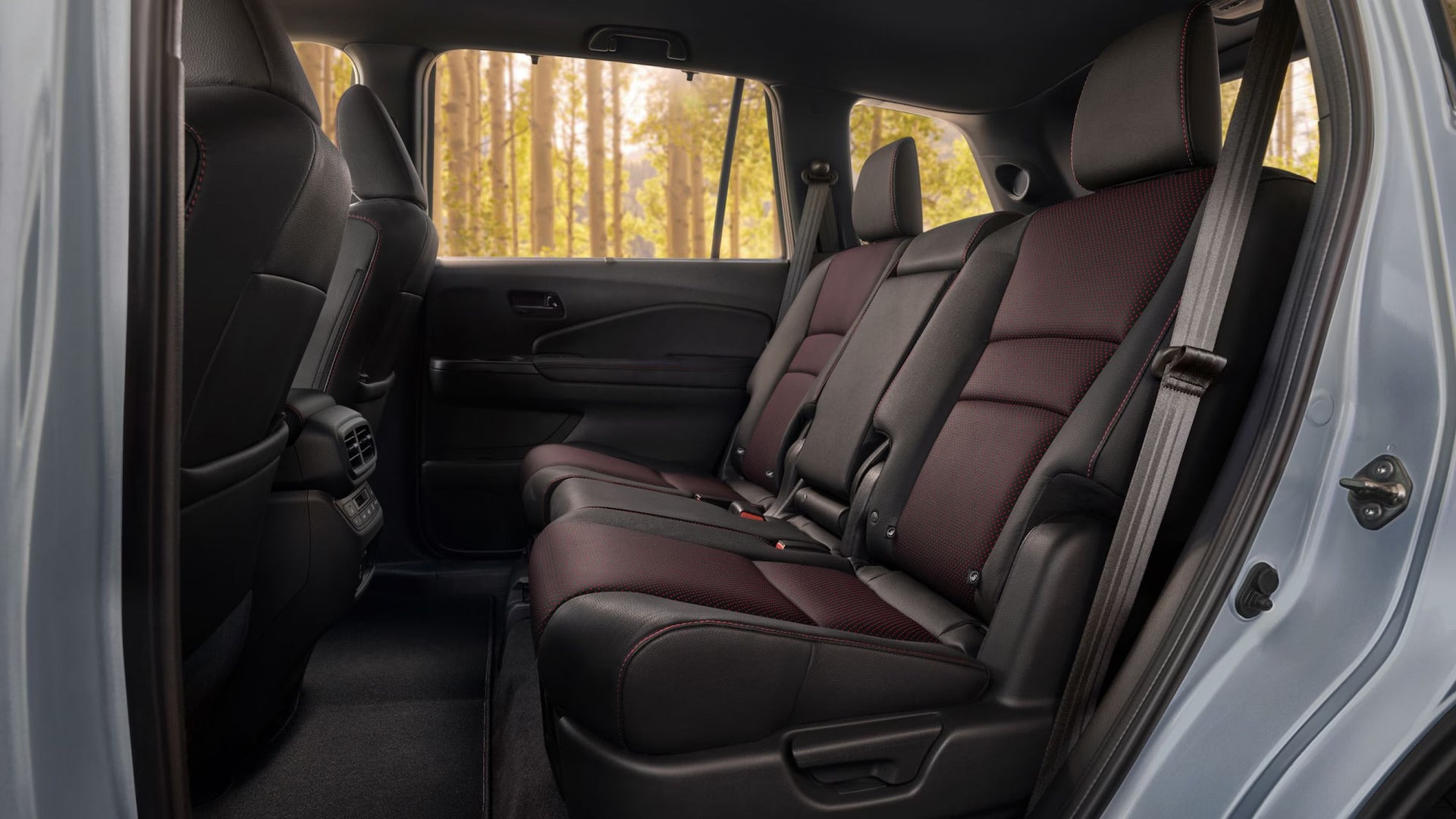 the back seats of a honda passport with black and dark brown leather interior