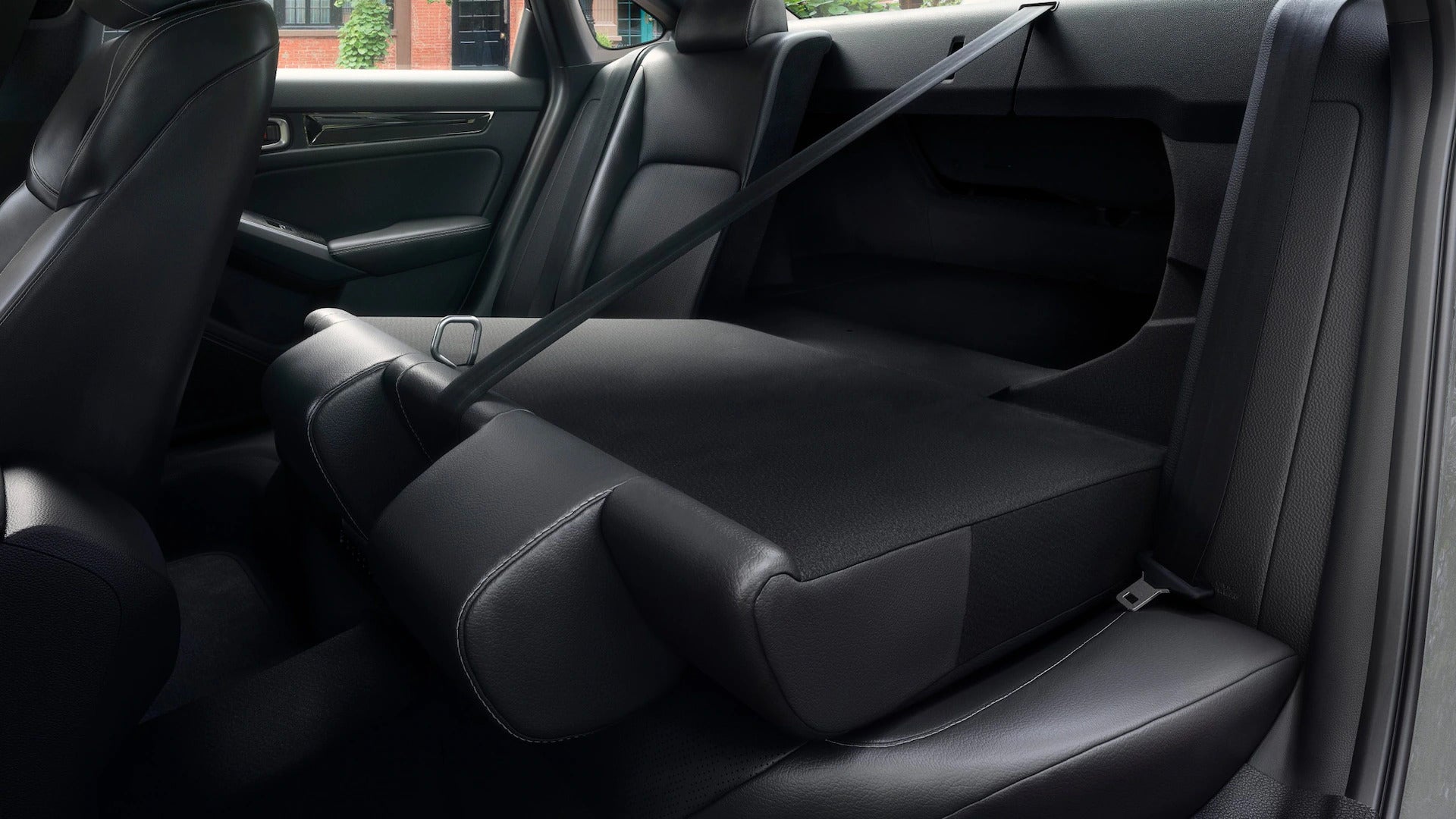 Interior view of the 2025 Honda Civic, featuring the rear seats folded down for additional cargo space.