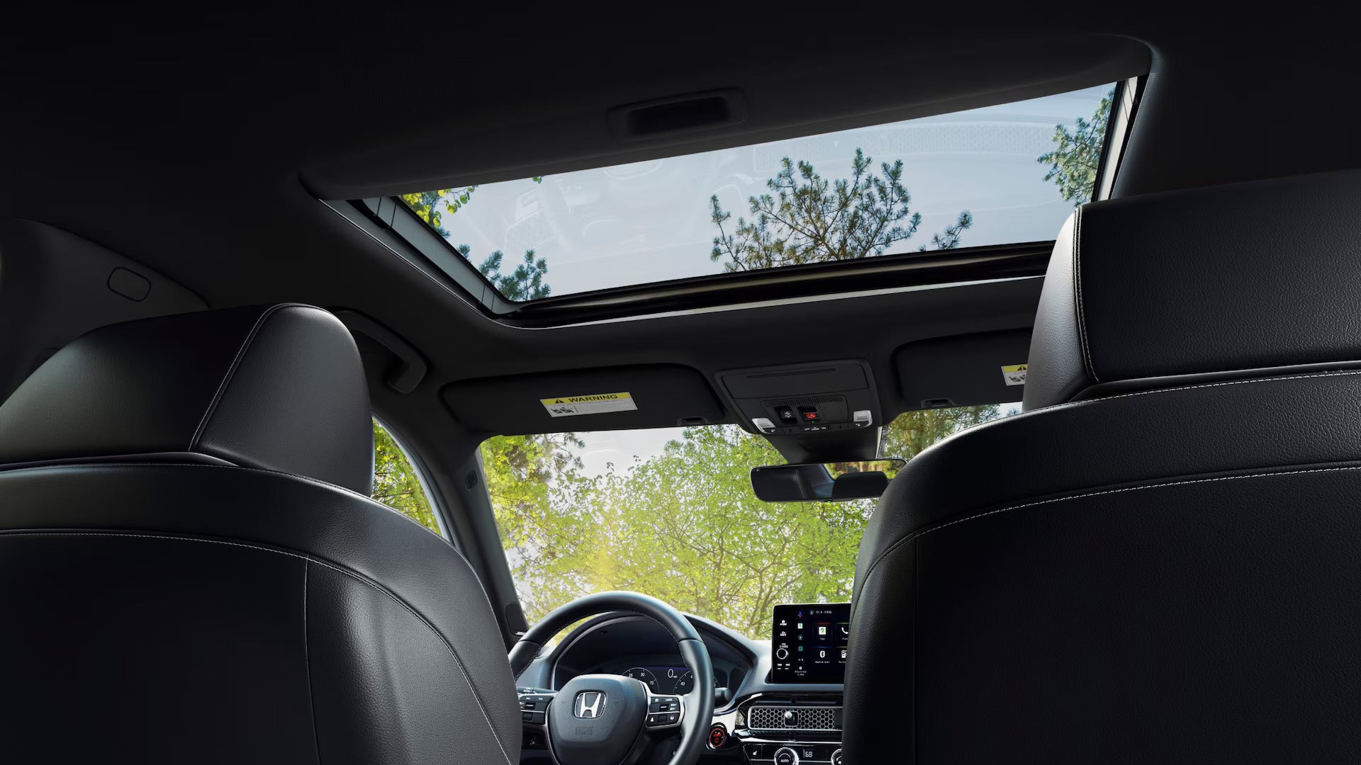 Interior view of the 2025 Honda Civic showcasing a sunroof and leather seats