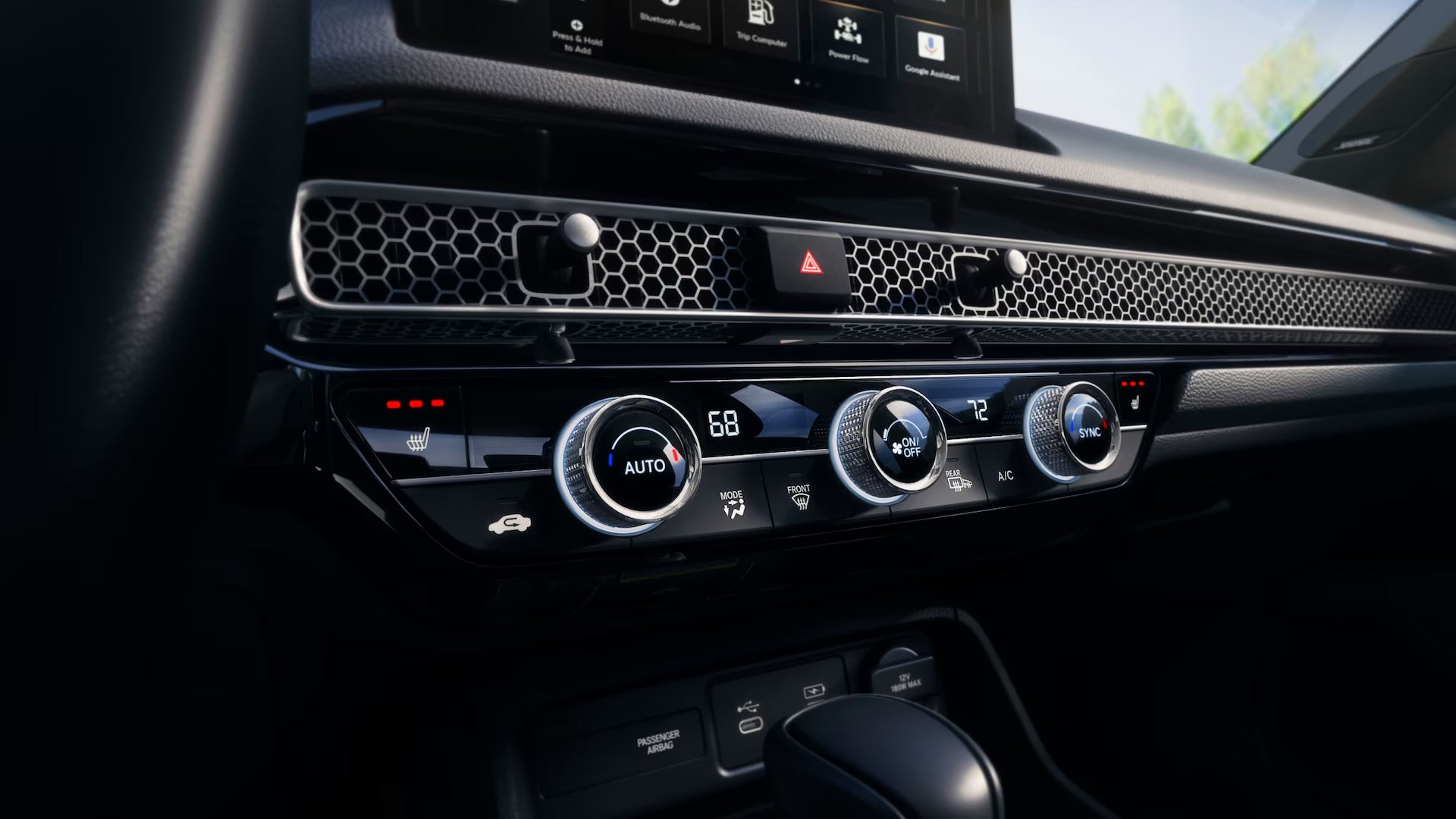 Close-up of the 2025 Honda Civic’s climate control panel, featuring digital temperature settings, heated seat indicators, and a modern honeycomb-patterned dashboard design.