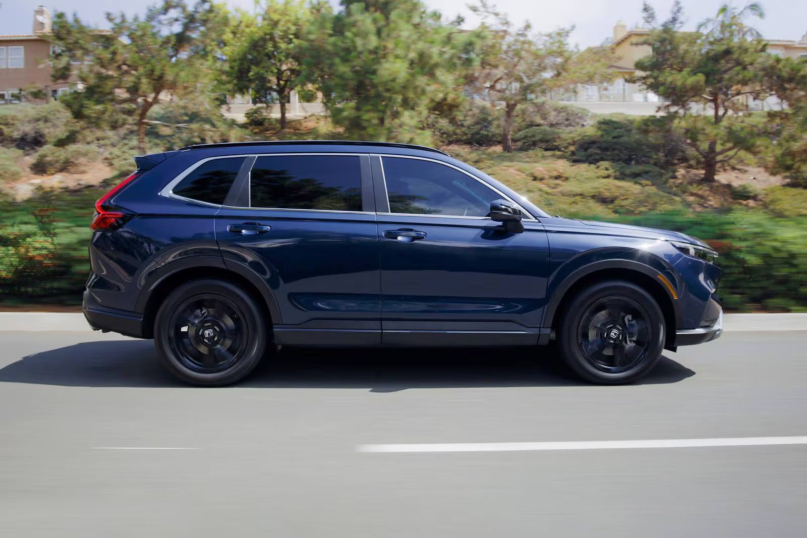 A blue car driving on the road.
