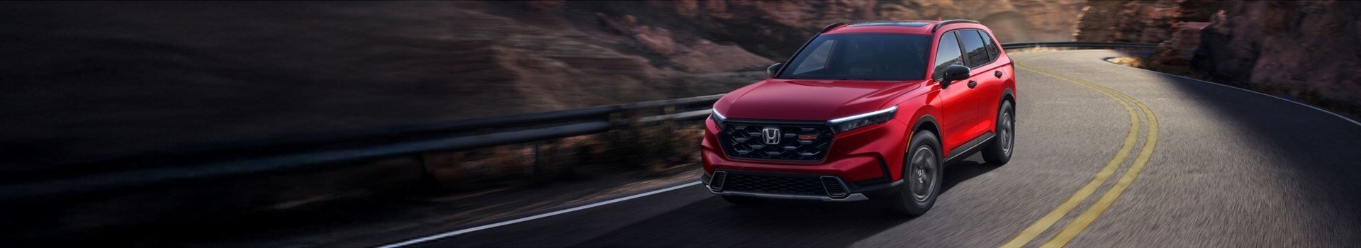 A red car driving on the road.