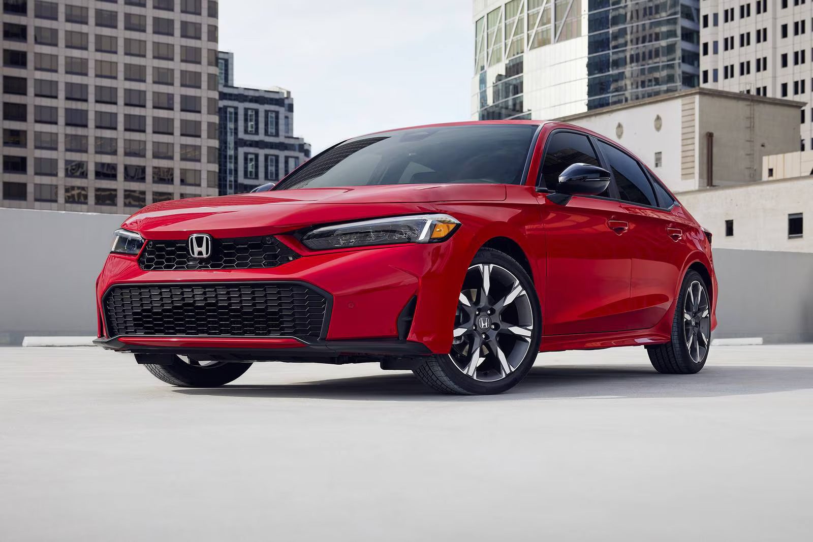 A red car drivin on the road.