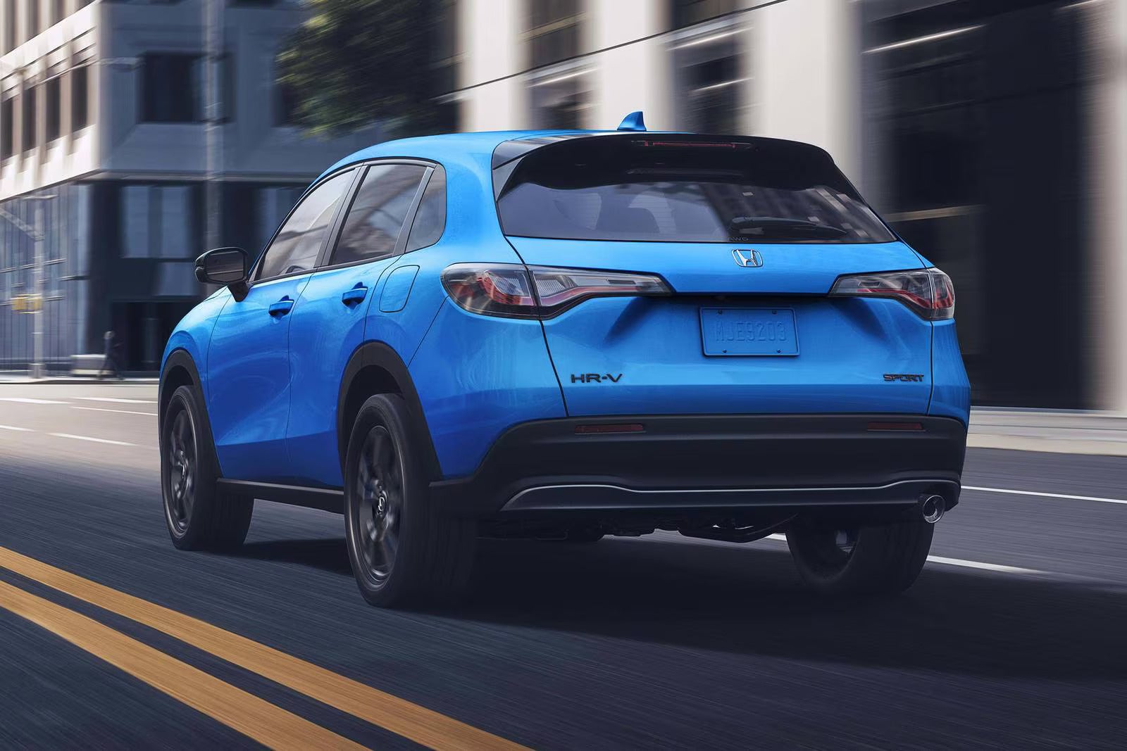 A blue car driving on the road.