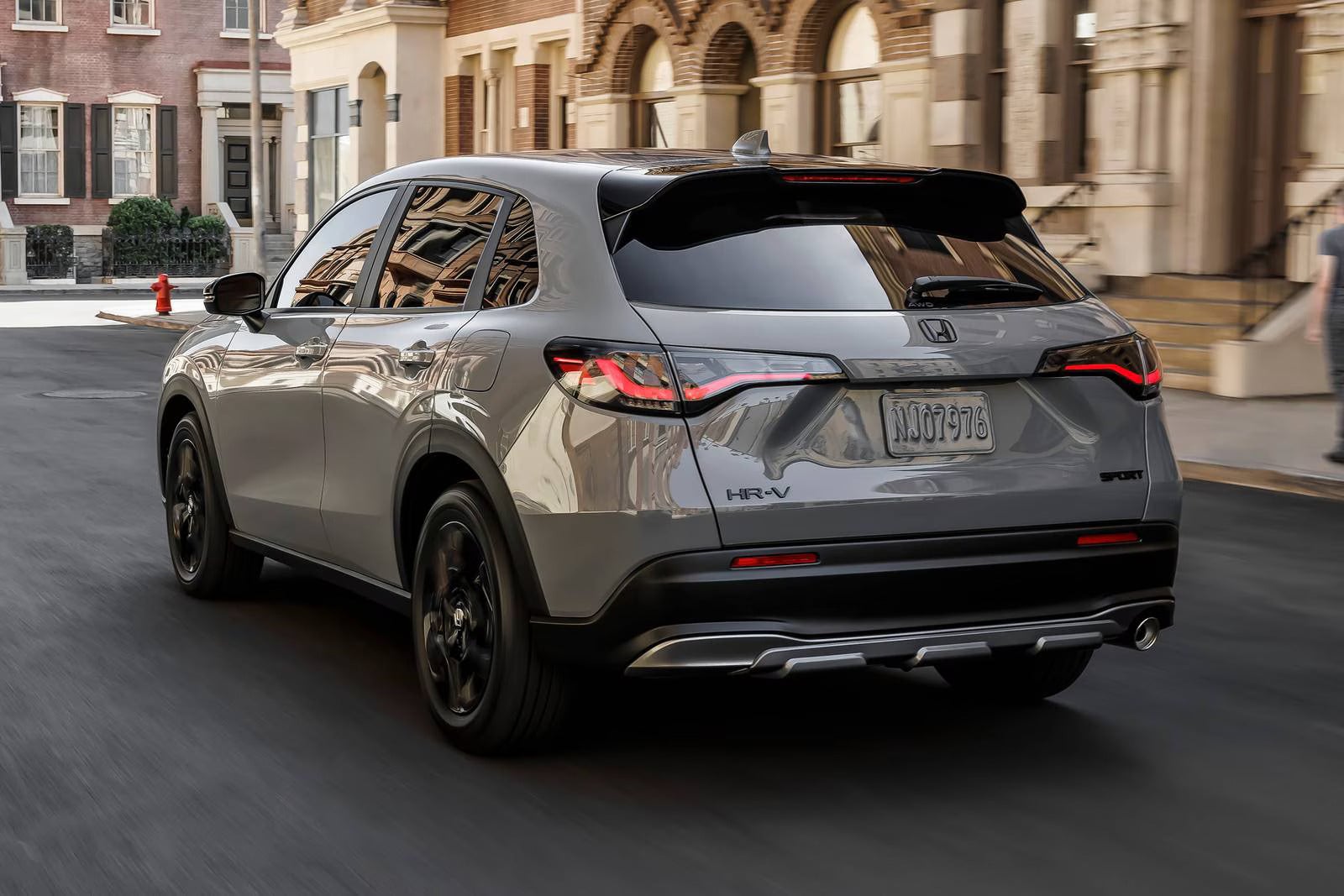 A gray car driving on the road.