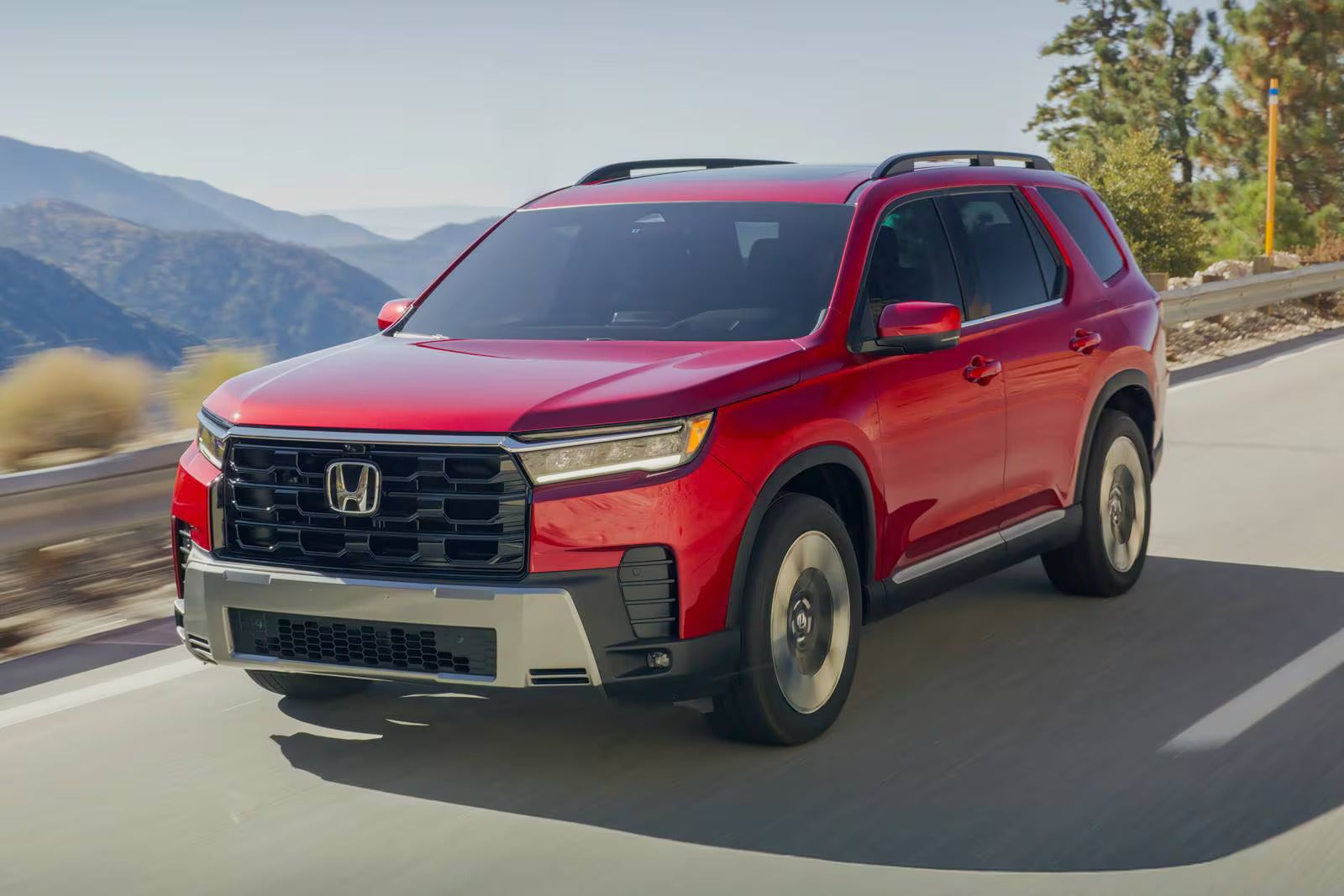 A red suv driving on the road,