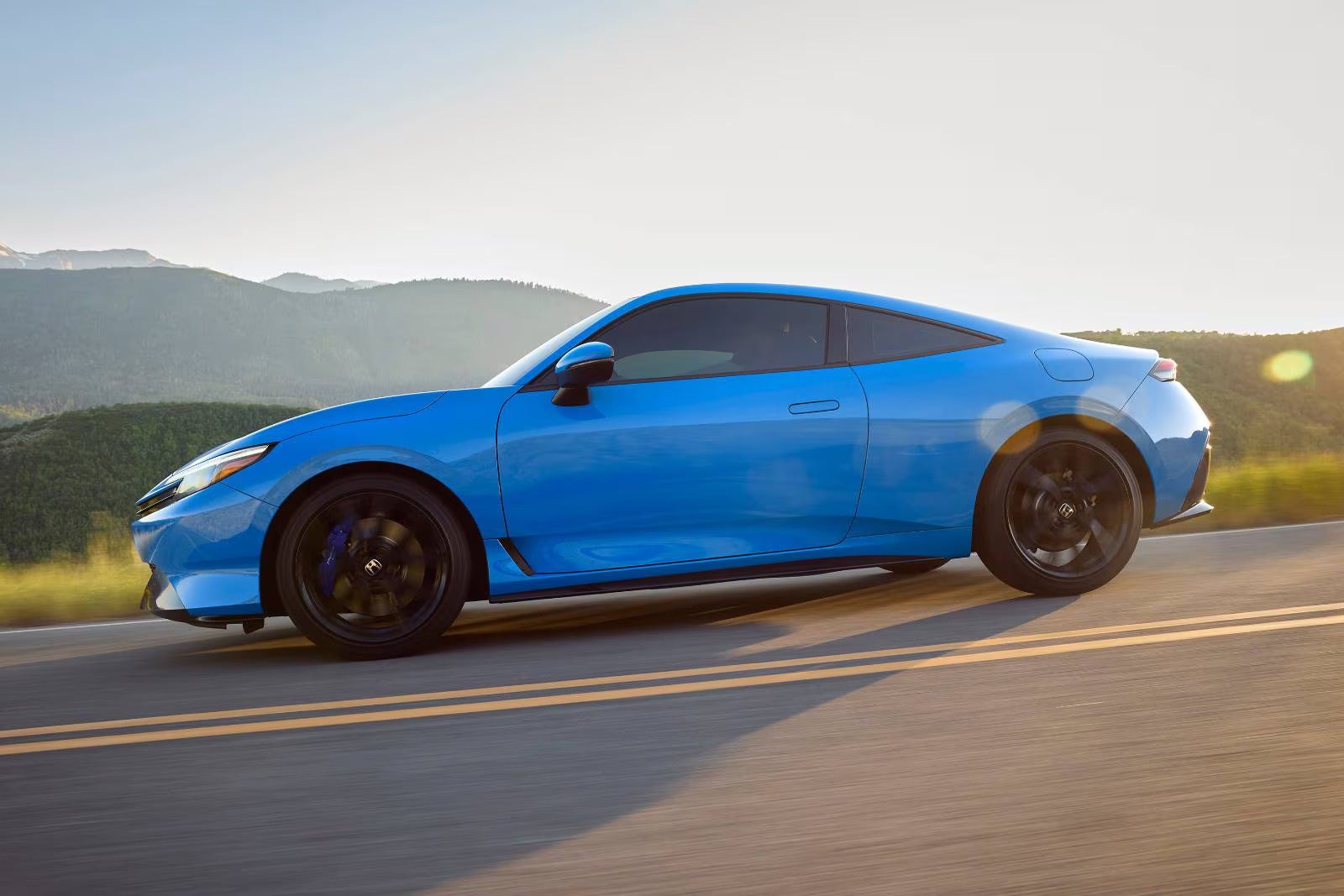 A blue car driving on the road.