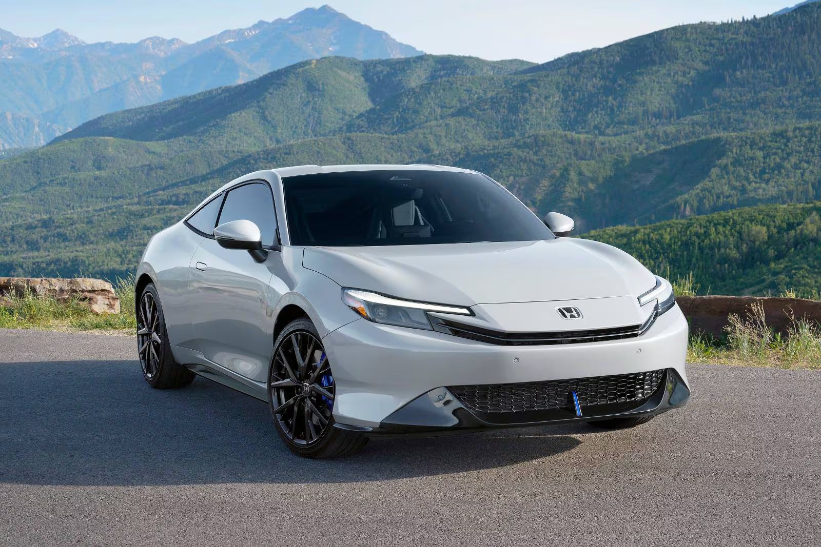 A blue car driving on the road.