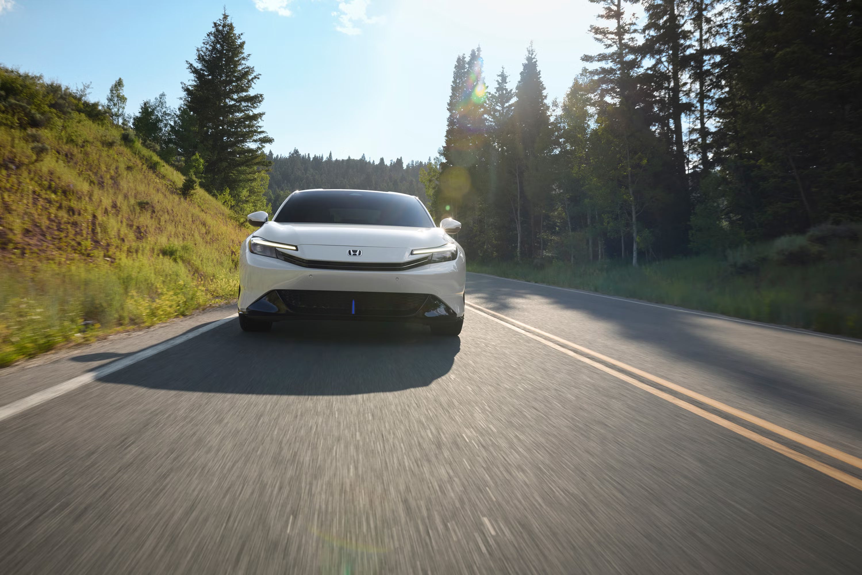 A white car driving on the road.