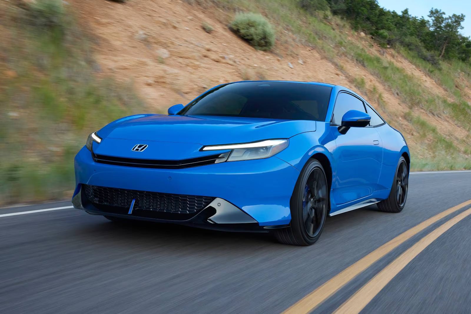 A blue car driving on the road.