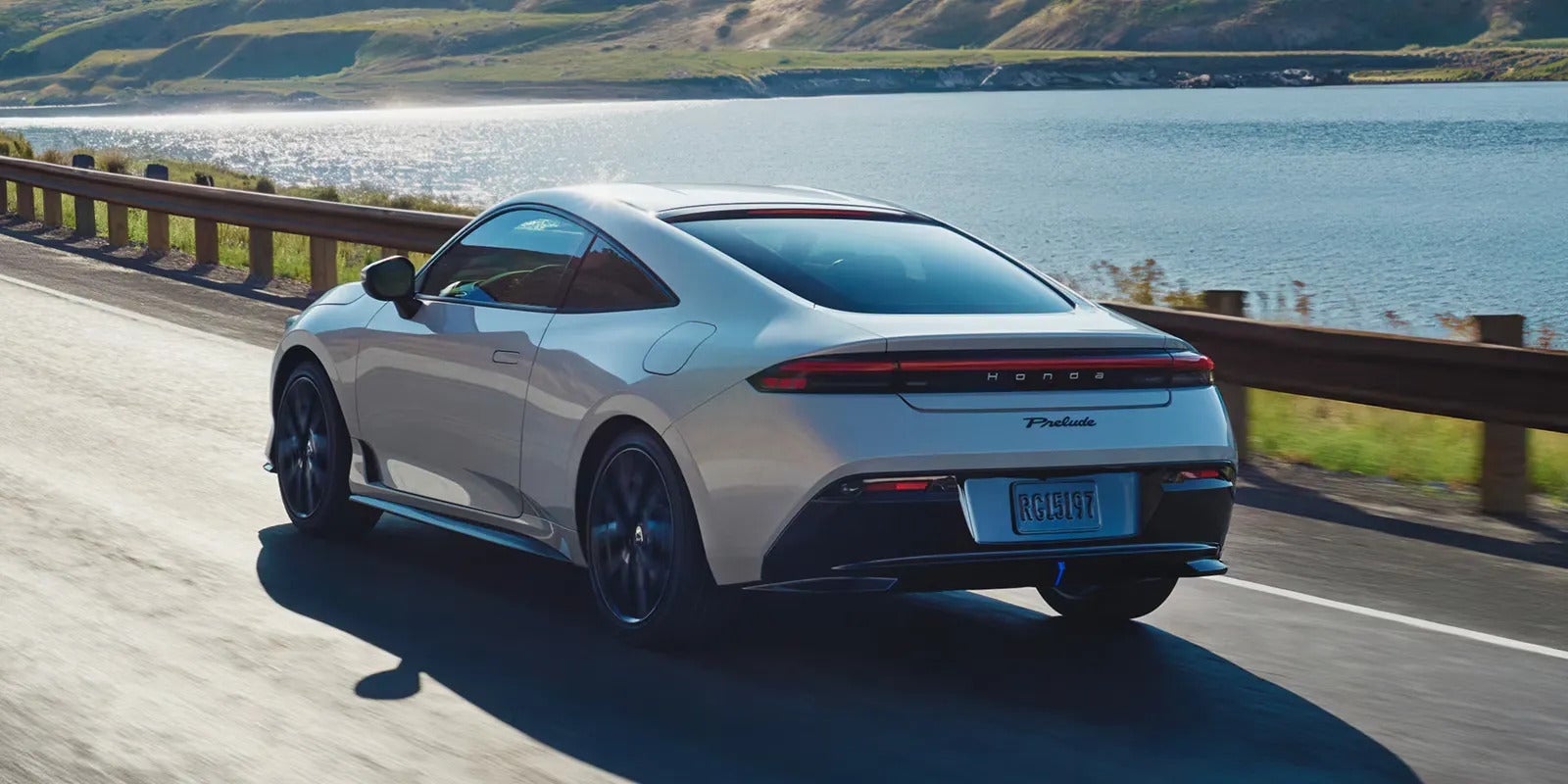 A grya prelude driving on the road.