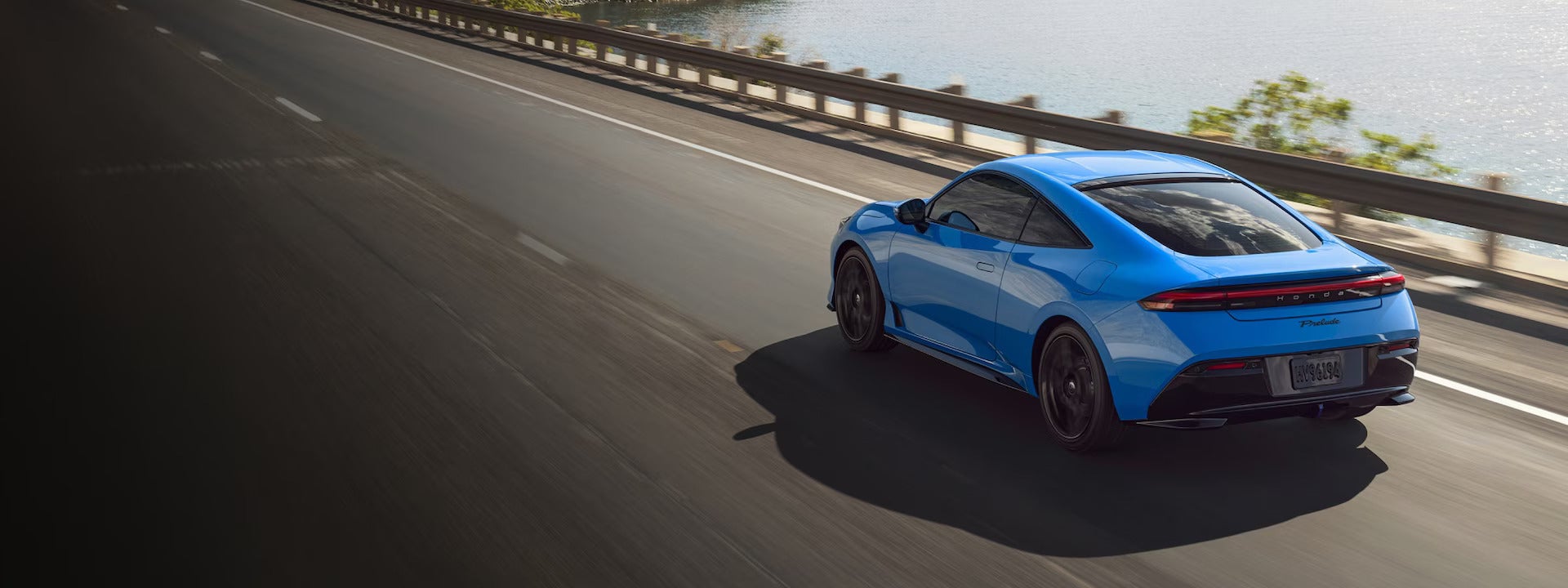 A blue car driving on the road.