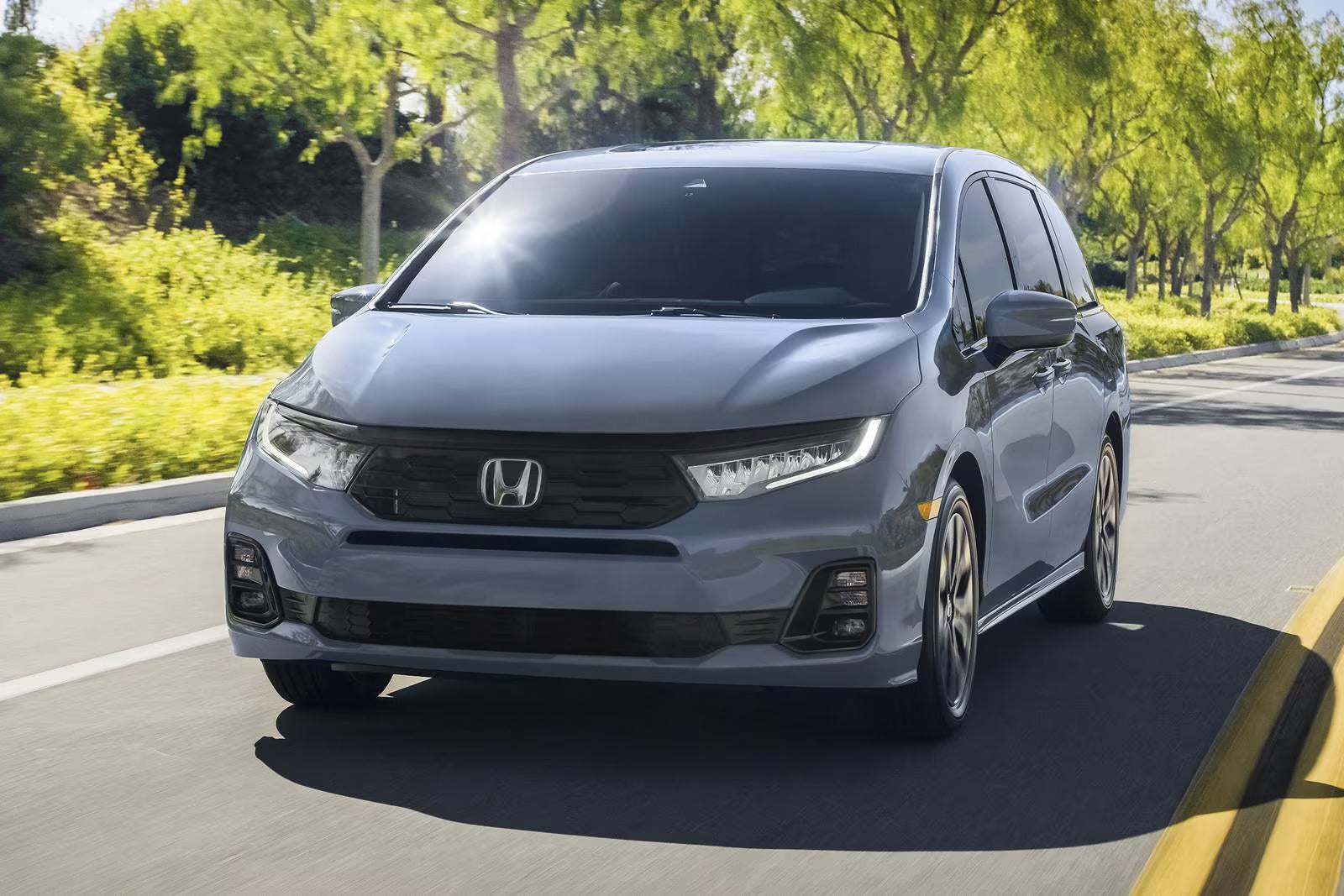 A black van driving on the road.