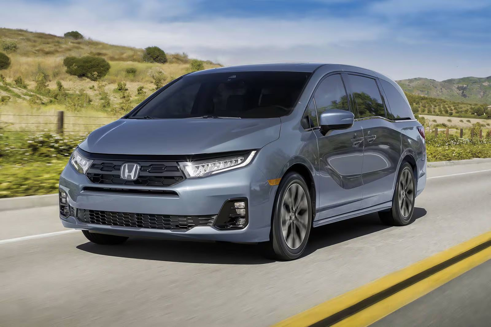 A gray van driving on the road.