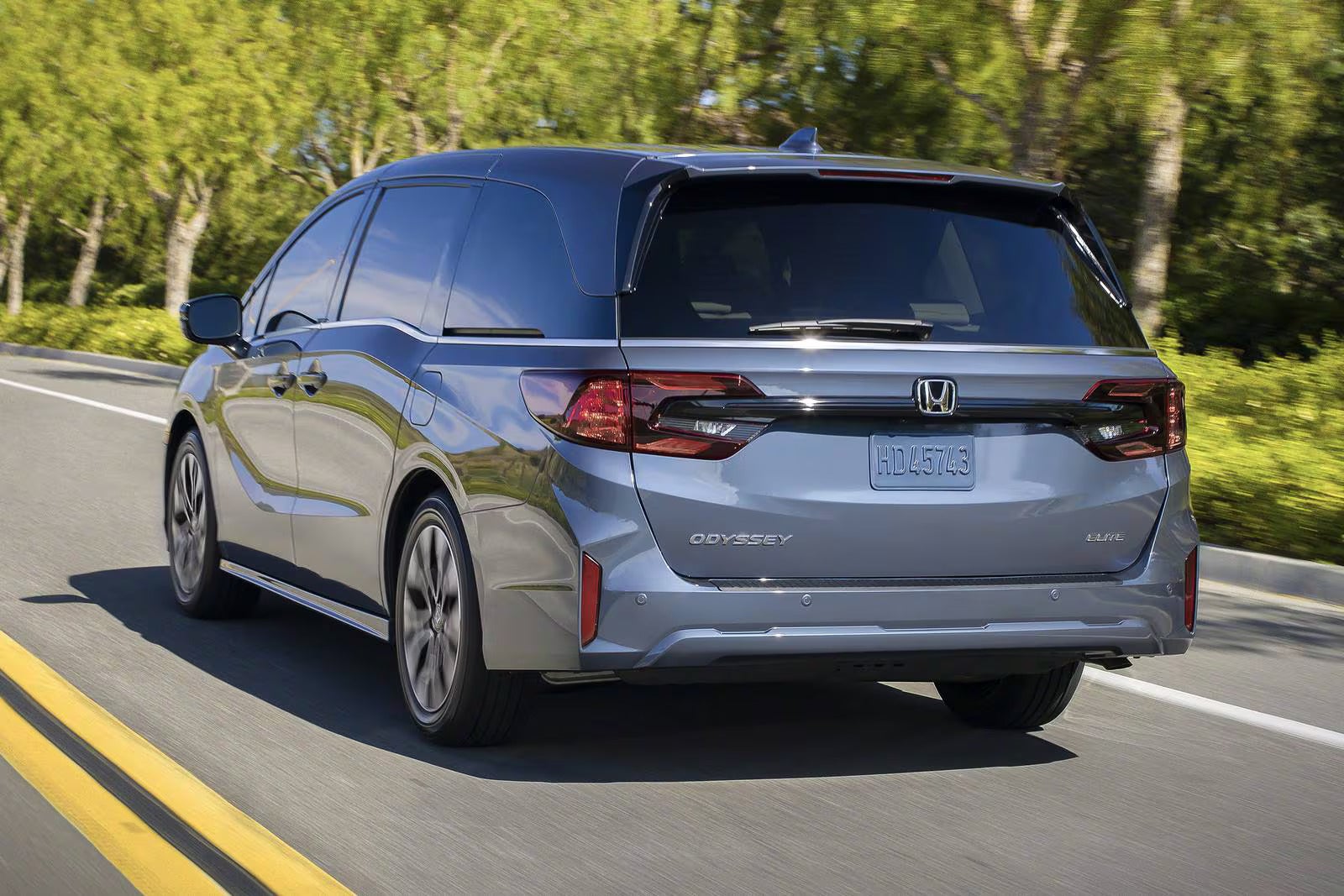 A gray van driving on the road.