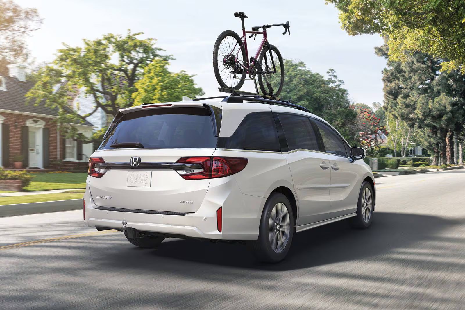 A white van carrying a bikes on the roof.