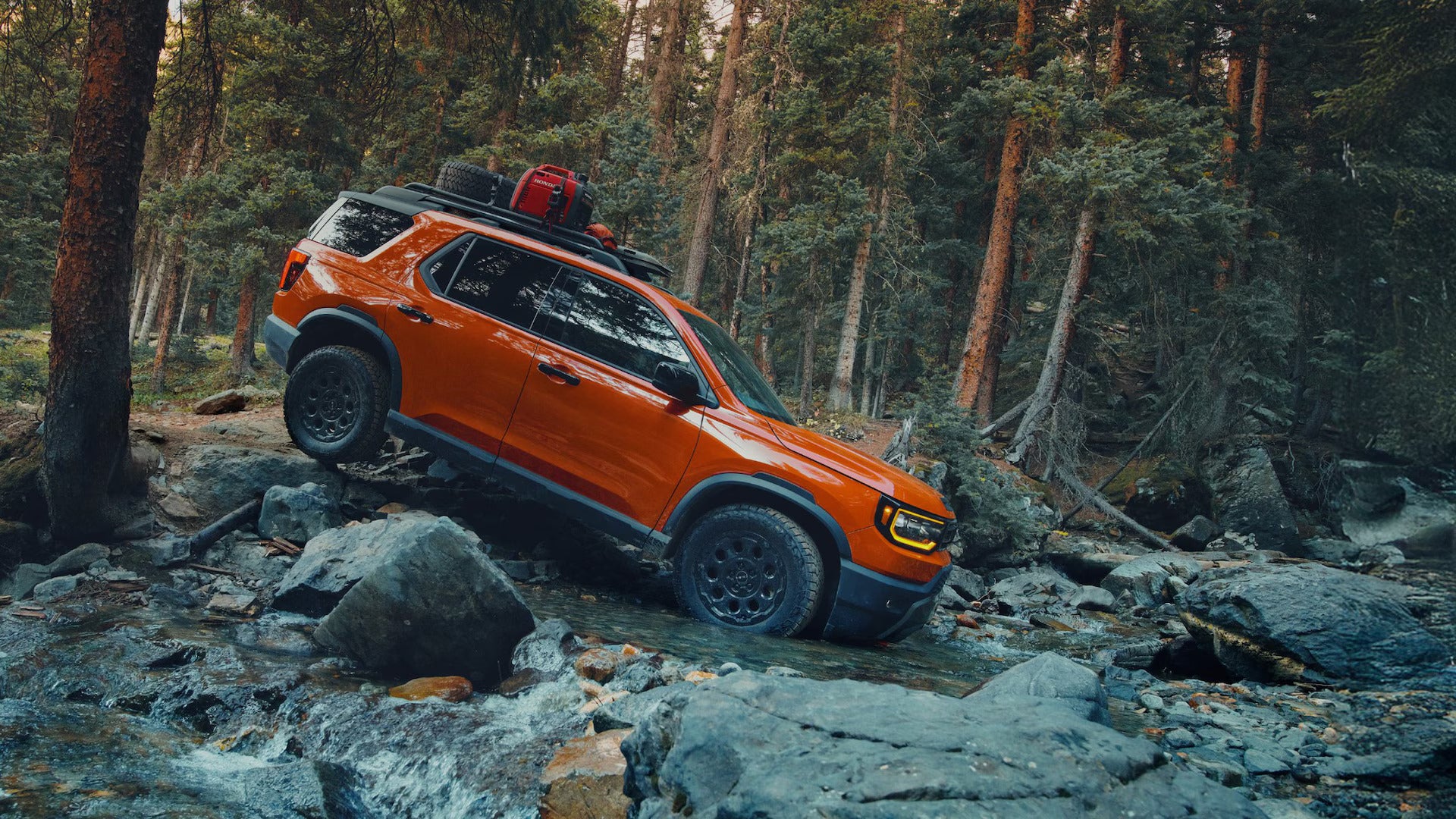 An orange suv driving off-road.