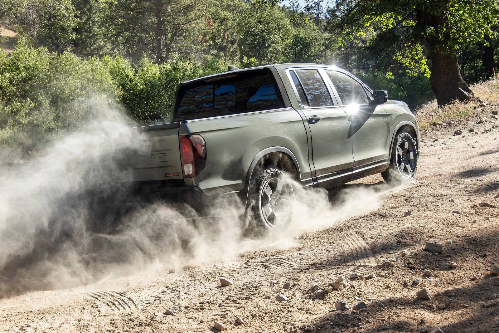 A green truck driving off-road.