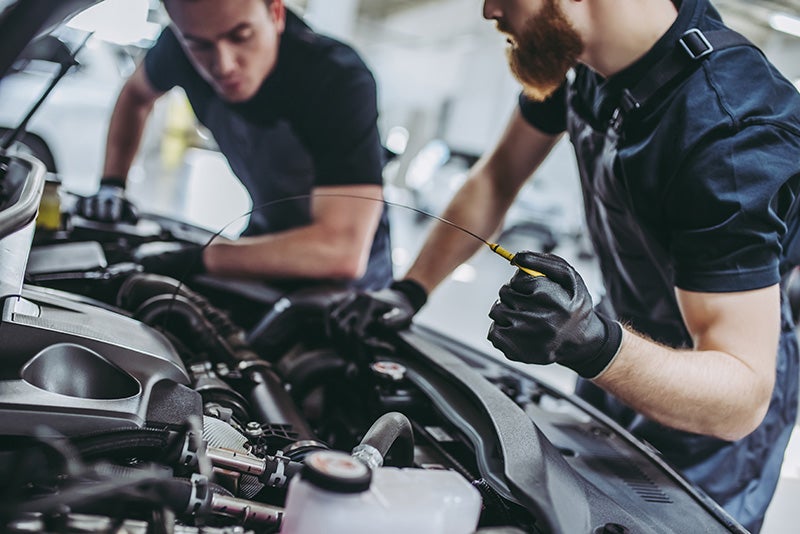 Two men working on a car.