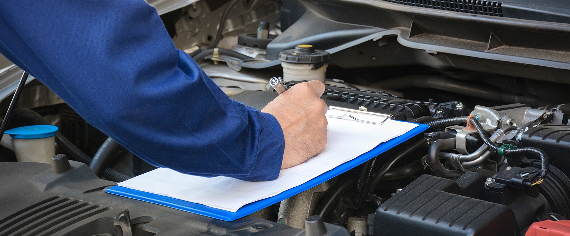 A man servicing a car.